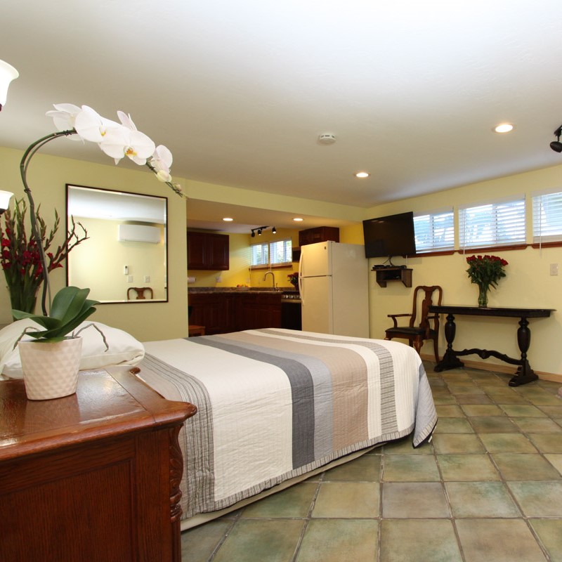 An extra-large suite with a large kitchen that has a full size refrigerator, microwave, coffee maker, and a spacious dining area.